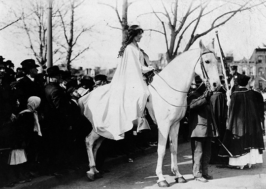 Inez Milholland Boissevain leading the 1913 Woman Suffrage Procession in Washington D.C., astride a white horse named Gray Dawn.