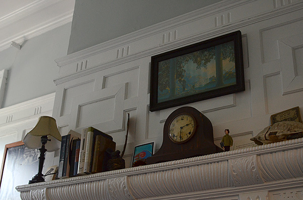 Closer view of mantle over fireplace, antique mantel clock center
