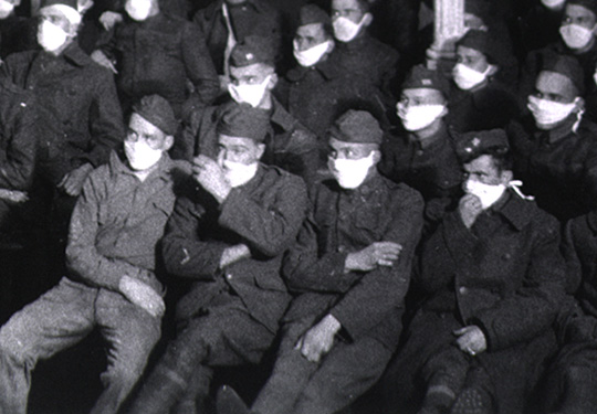 Patients at moving picture show wearing masks because of an influenza epidemic.