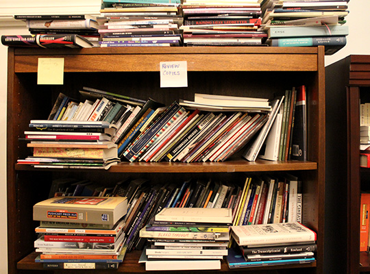 Closeup of book shelf; review copies