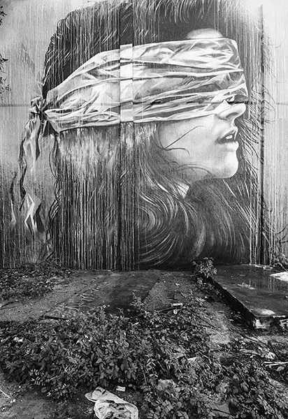 Photograph of street art of a blindfolded person.