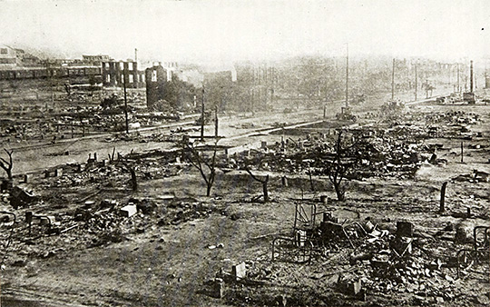 Burned out Greenwood district in Tulsa, Oklahoma; only some building shells in the left rear distance standing.