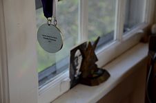 Medal reading “Literary Award for Poetry / Claudia Emerson / 2013.”