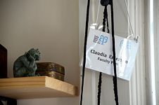 Small wooden box,  seated gargoyle statue, head in hand, facing Palm Beach Poetry Festival name tag reading “Claudia Emerson / Faculty Poet.”