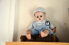 Vintage baby doll wearing a “poetry” button.