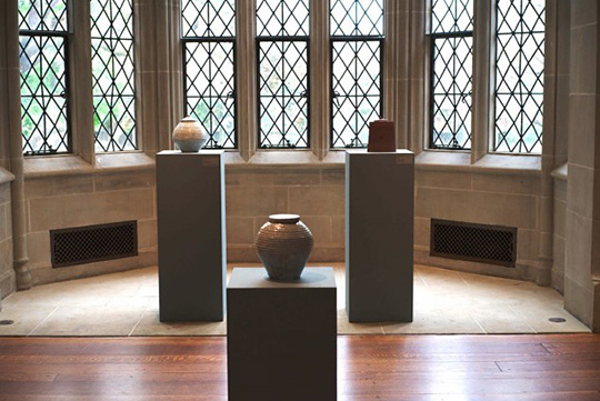 Three cinerary jars on display columns