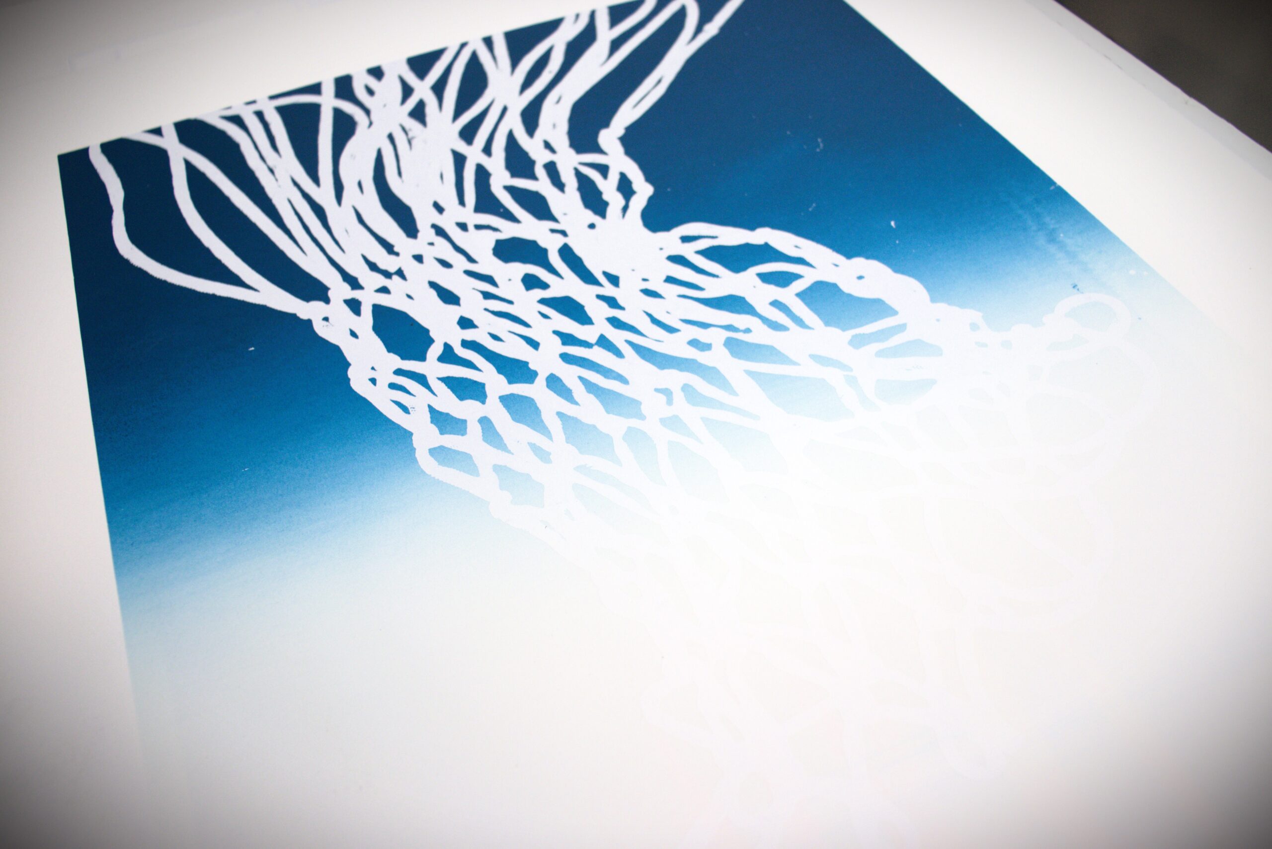 A gradated print, blue to white, featuring a basketball net.
