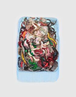 Woman's facial features emerge from a collage of multi-colored fabrics surrounded by light blue fringe.