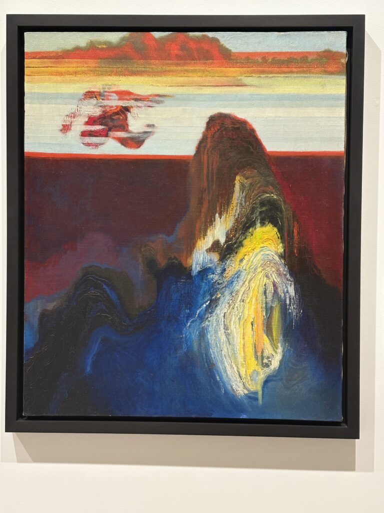 Abstract landscape featuring dark blue, yellow, reds, and oranges.