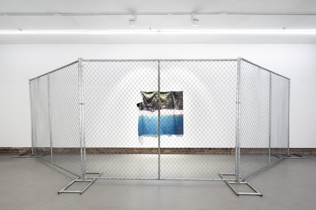 Chainlink fence installed in white, well-lit room, fencing in a beach landscape image.